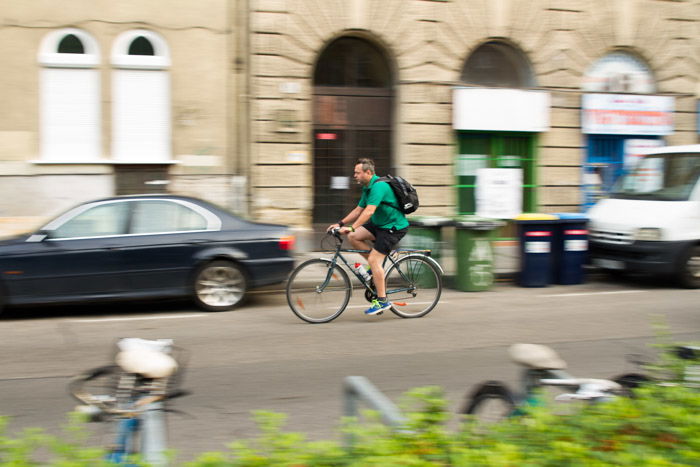 A blurry shot of a cyclist on the street