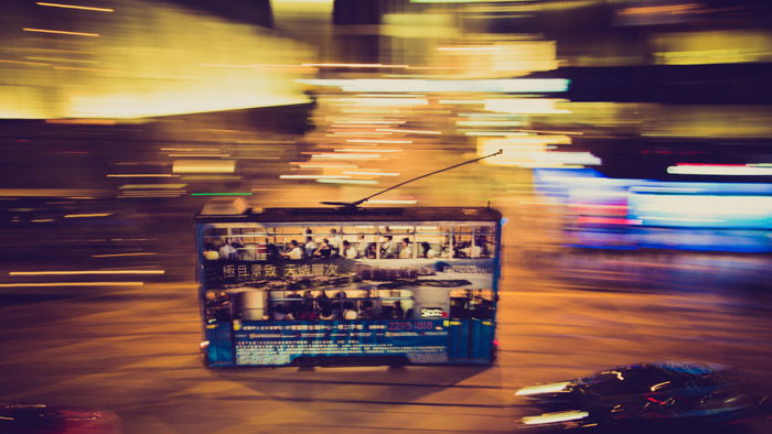 Colorful and blurry shot of a bus on a street at night