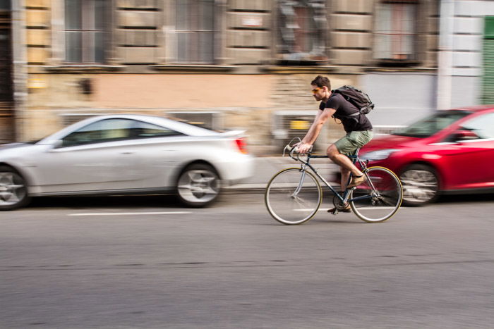 A cyclist on the street with motion blur in the background