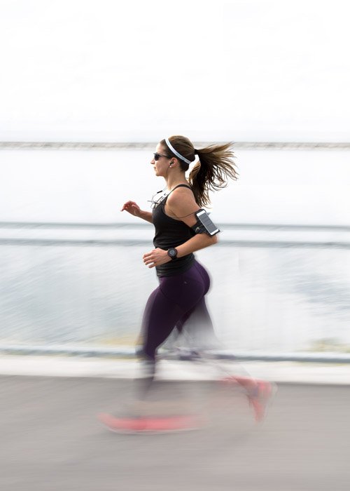 A panned shot of a female jogger