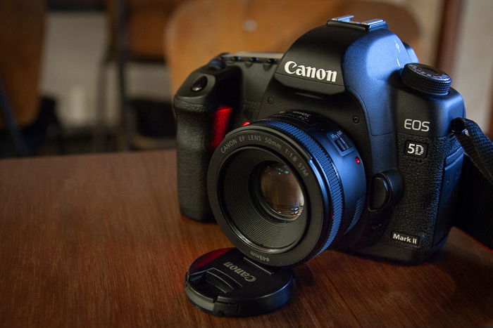 A photo of a canon DSLR on a cafe table used as alternative camera equipment to a tripod.