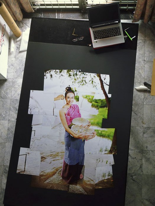 A photomontage on a large table as it is being created