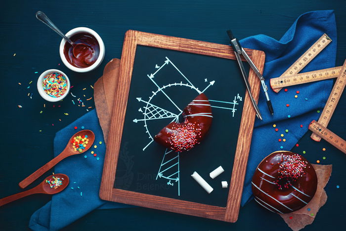 Overhead still life photography ideas of fun food photography on dark background with chalk drawings