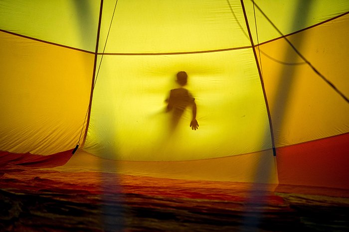 Earl Richardson surreal photography of a persons silhouette seen through a yellow tent