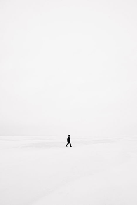  Emile Seguin surreal photography of a person walking through a stark white landscape