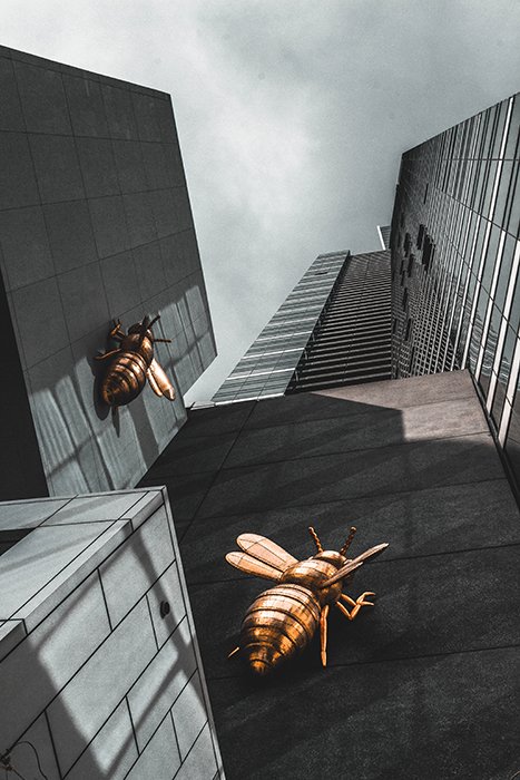 Oliwier Gesla photo of metal wasps scaling a skyscraper - surreal photography