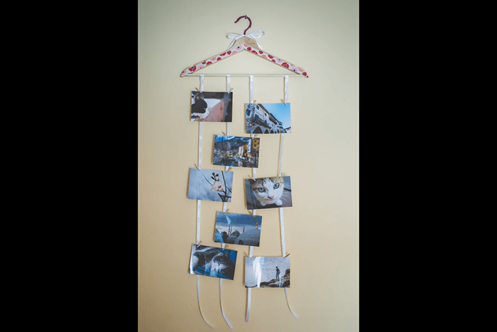 Pictures hanging from a clothes hanger like a mobile as an idea of what to do with photos
