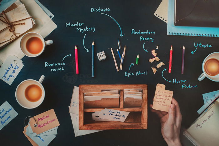 Overhead still life of coffee cups, pencils and writing equipment