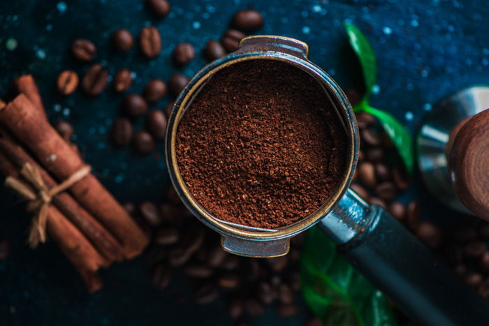 Overhead still life of coffee brewing equipment on dark background