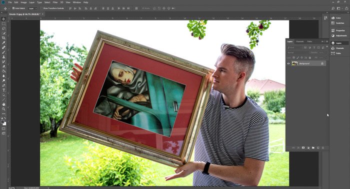 Screenshot of Photoshop editing a picture of a man holding a framed painting - droste effect step one
