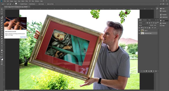 Screenshot of Photoshop editing a photo of a man holding a framed painting - droste-effect step six