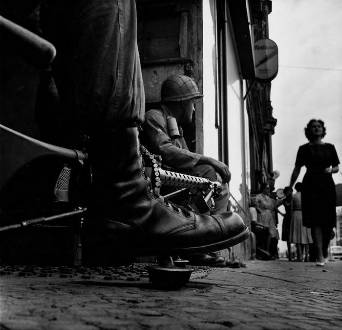 Close up of soldier's boot next to a machine gun on a German street