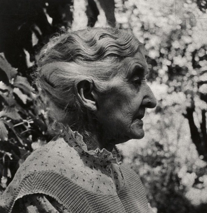 Side profile of old lady in a garden