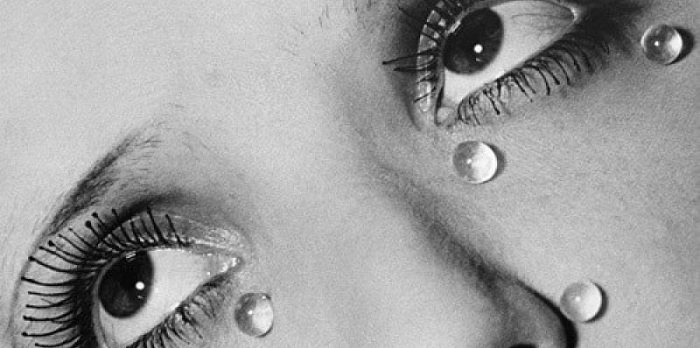 Close up of woman's eyes with water drops on her face