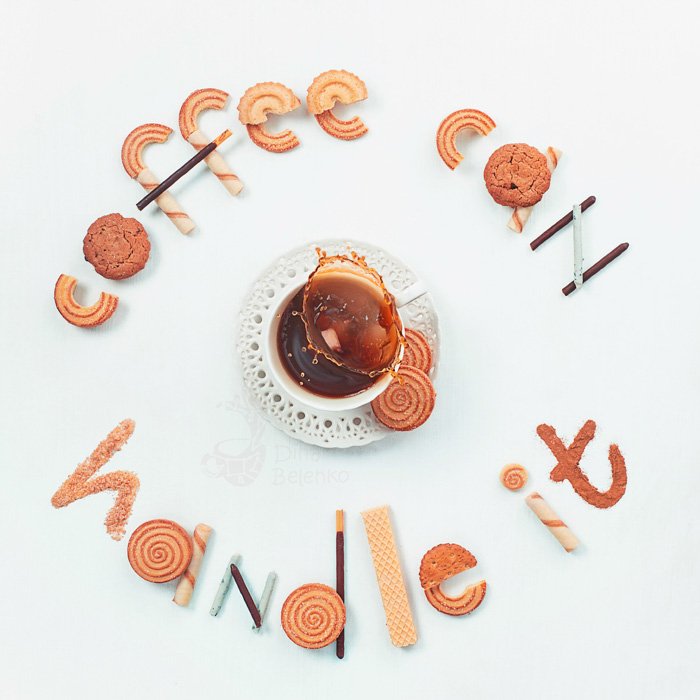 An overhead food art shot featuring coffee cups, saucers, biscuits with food typography message 'coffee can handle it'.