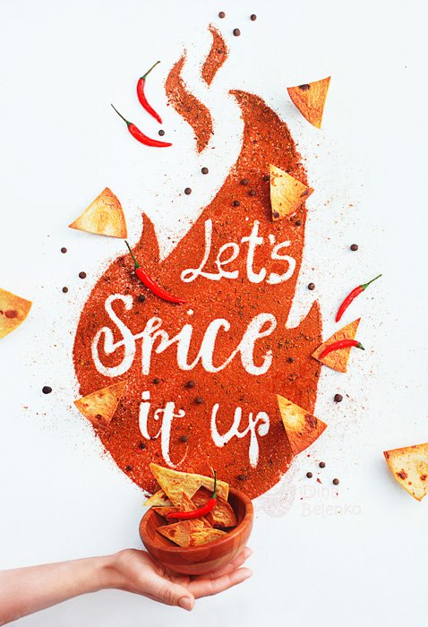 A hand holding a bowl of chips with the typography message 'lets spice it up' with nachos and spices