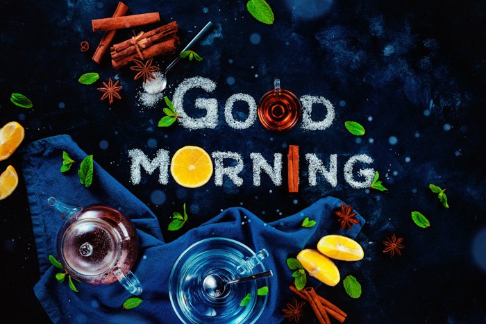 An overhead food art still life with the words 'good morning' created with sugar, fruit and other food typography props 