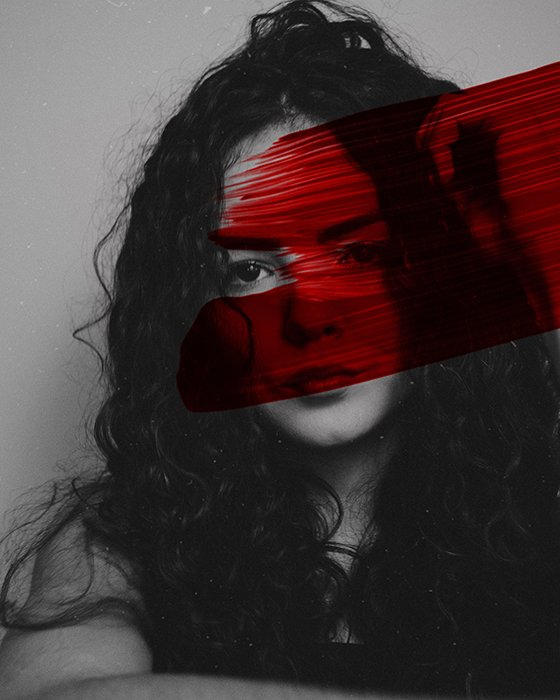Um retrato preto e branco de uma garota manchada com tinta vermelha