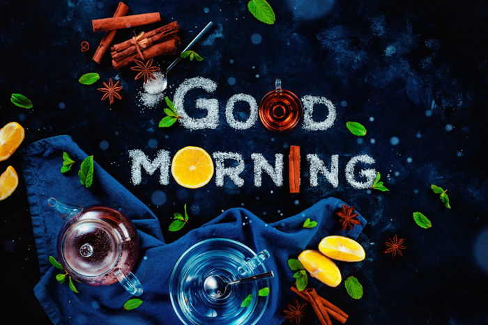 An overhead food art still life with the words 'good morning' created with sugar, fruit and other food typography props