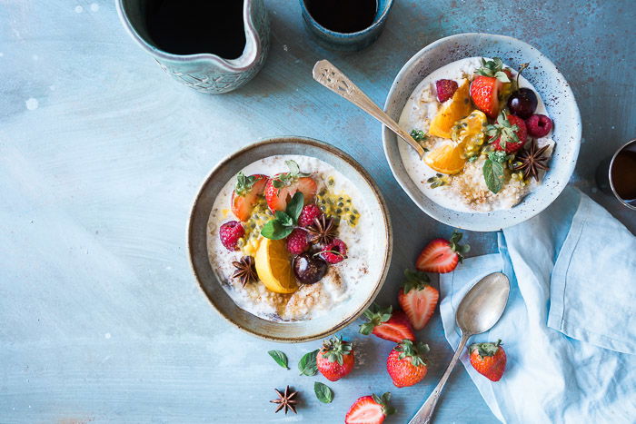 An overhead shot of two bowls of fruity dessert on light background - commercial freelance photography