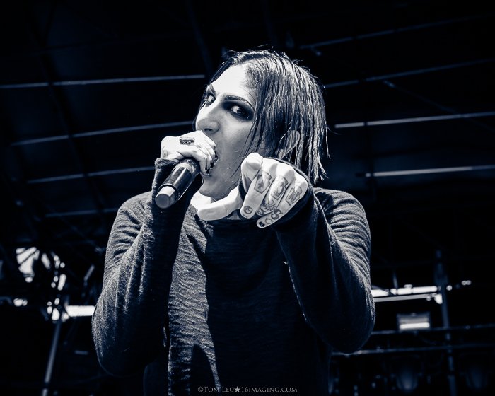 A black and white concert photography live shot of a singer onstage