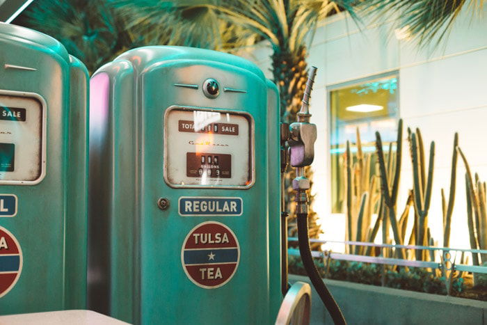 Two green filling station pumps shot with a nifty fifty 