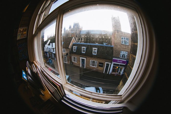 A street view through a window showing fish-eye distortion