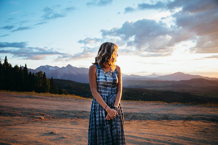 Portrait of a girl standing in front of a beautiful landscape