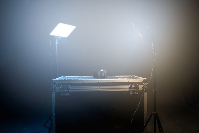 Photo of a minimal studio with a table and lighting