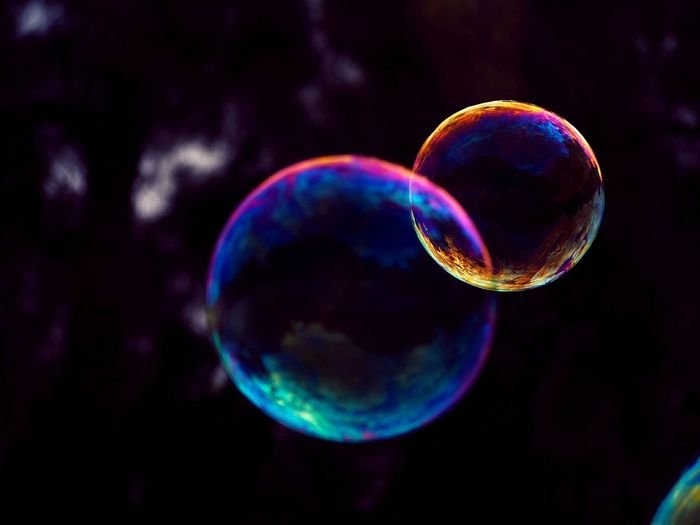 macro photo of two colorful soap bubbles 