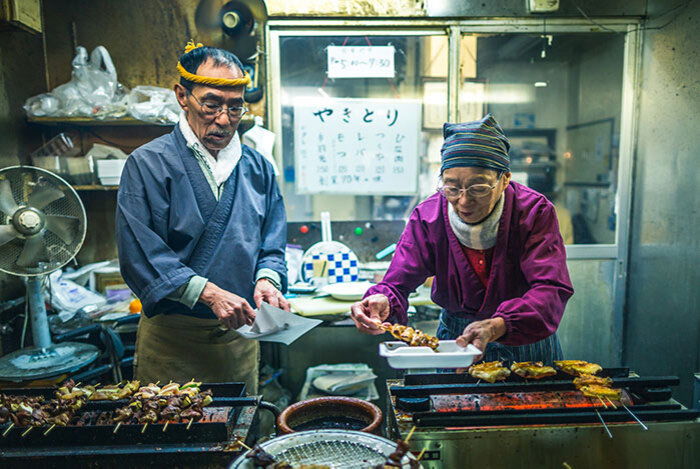 Photo of people at an Asian market food stall shot with a wide angle lens