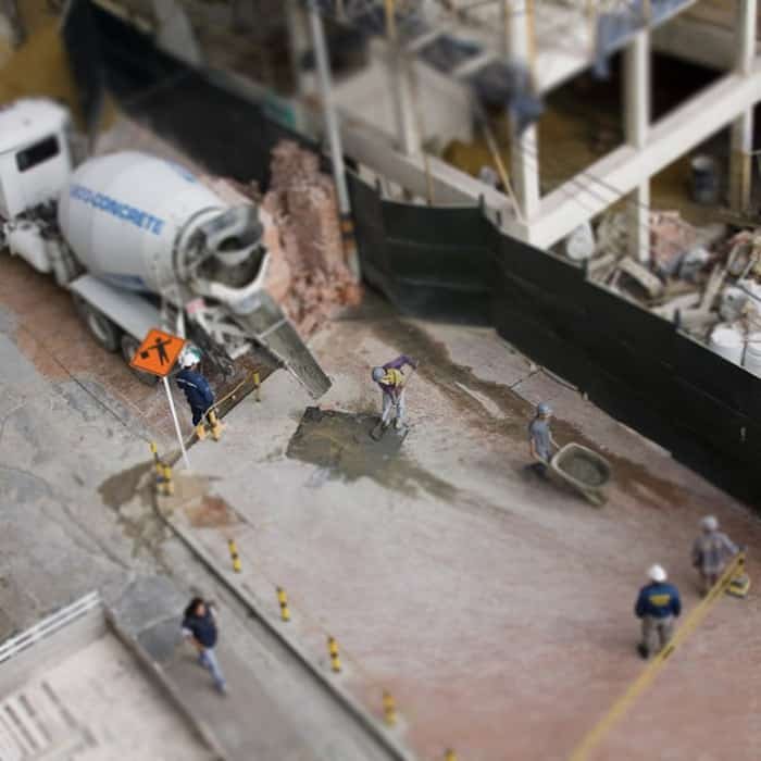 Overhead shot of a construction site with men working using tilt-shift photography