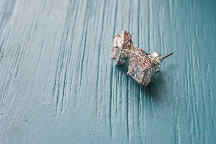 Close up of diamond earring on turquoise background -best tripod for wedding photography gear