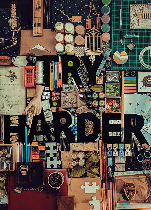 A creativestill life with the silhouette of the word 'Try Harder' comprised of many small objects