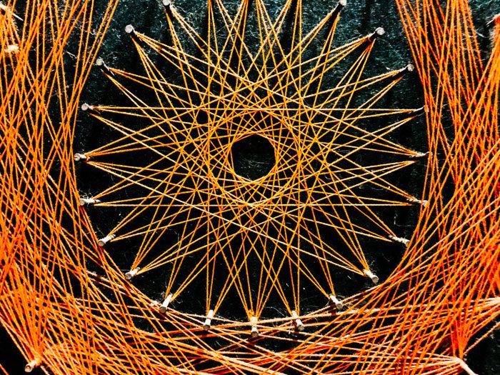A close up of a pattern made with orange twine - smartphone abstract photography tips
