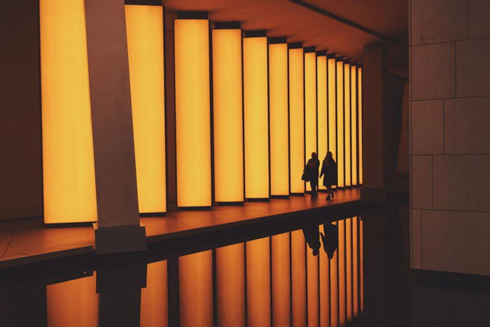 The interior of an impressive orange lit building