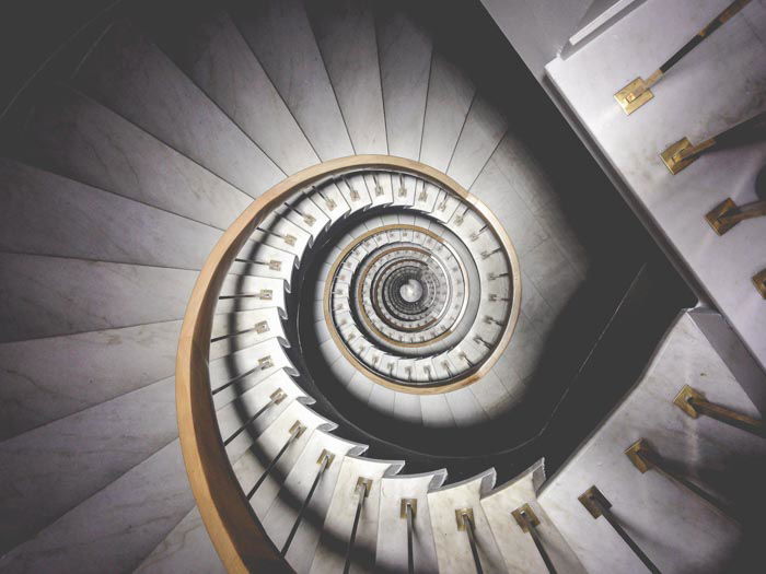 A photo looking down an elaborate spiral staircase