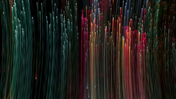 Colorful lines of vertical light against a dark, black background