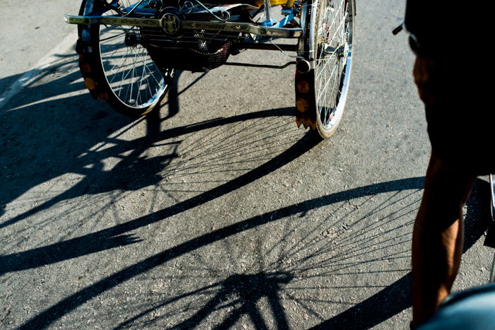 The shadows of bicycle wheels on the concrete road