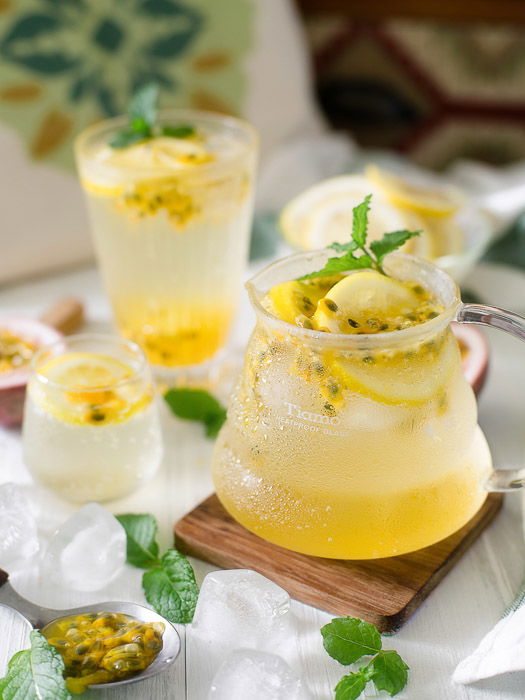 Bright and airy food photo of a jug of fresh lemonade and glasses