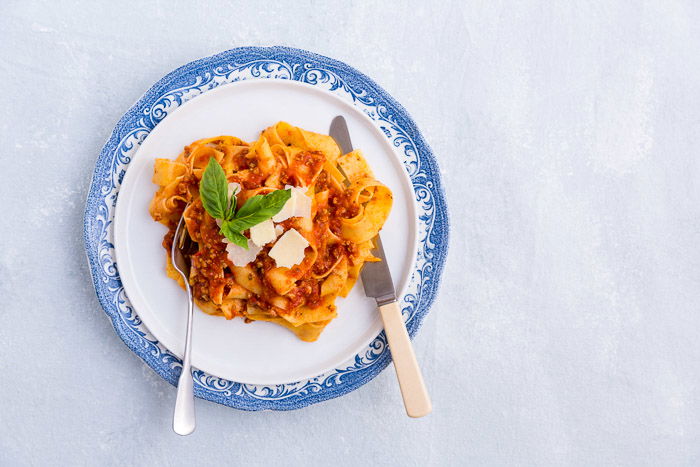 An overhead food photography shot of a bowl of Pappardelle 