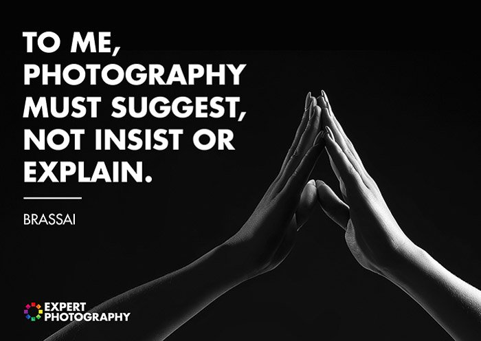 A black and white close up shot of two hands touching overlayed with a quote from Brassai on what makes a good photograph