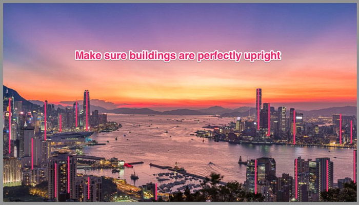 A fantastically colored cityscape with the message 'make sure buildings are perfectly upright'.