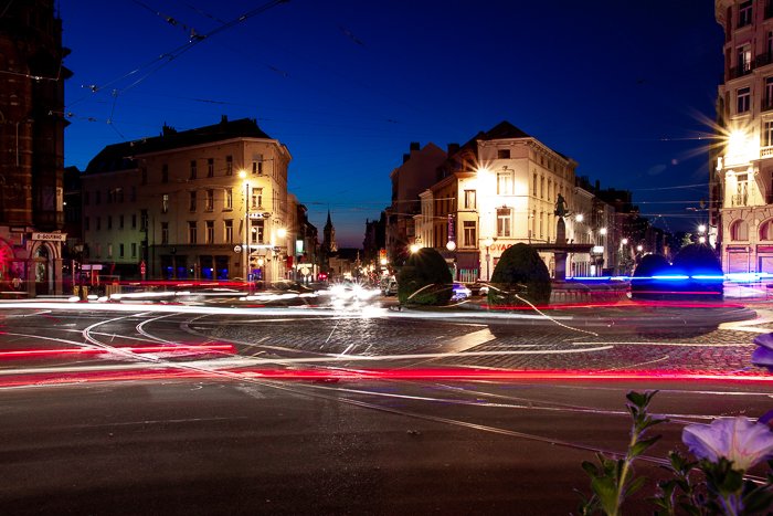 Urban scene with many light trails going all in different directions making a confusing image.