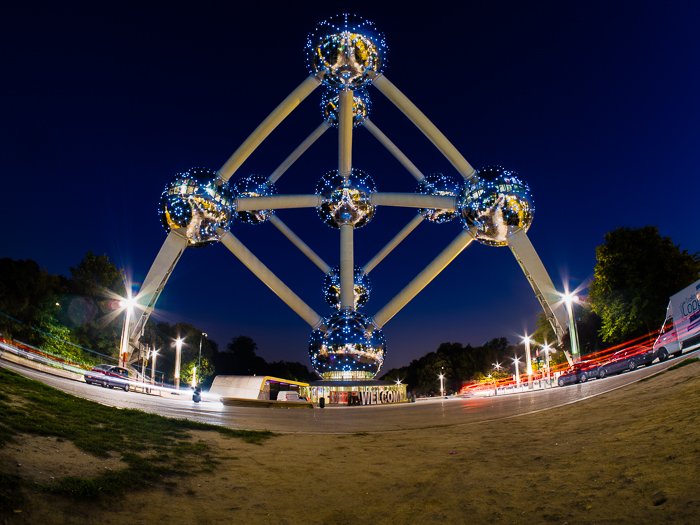 Streams of light trails from traffic passing under Brussels' most iconic landmark
