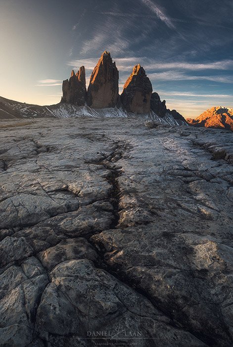 Fantastic view of rocky mounatins with cracked earth in the foreground