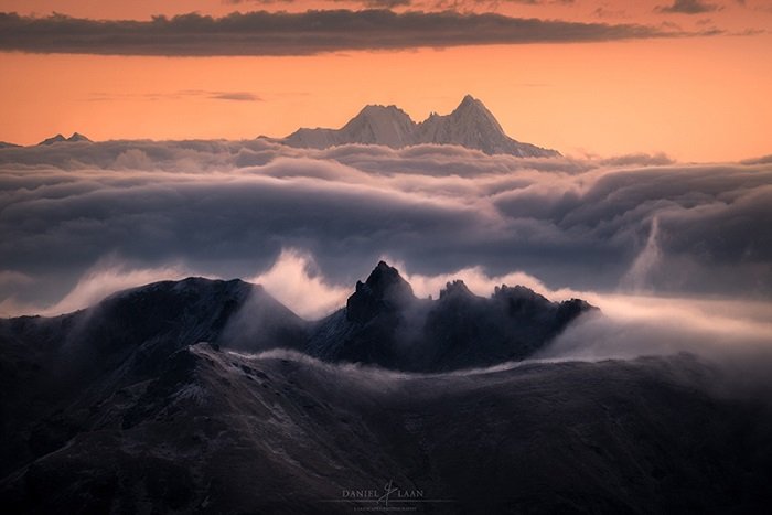 Reddening of the sky over a seas of clouds in the majestic Dolomites.