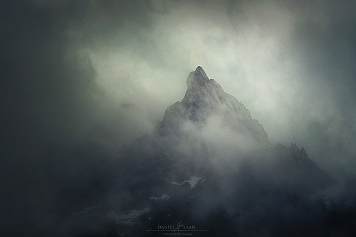 Atmospheric misty shot of a lone peak in the Swiss alps