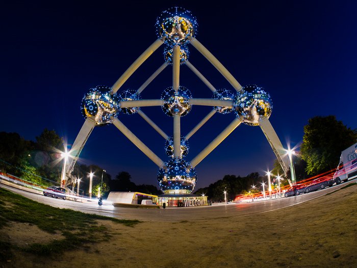 The Atomium at night with traffic passing under photographed with fish eye lens