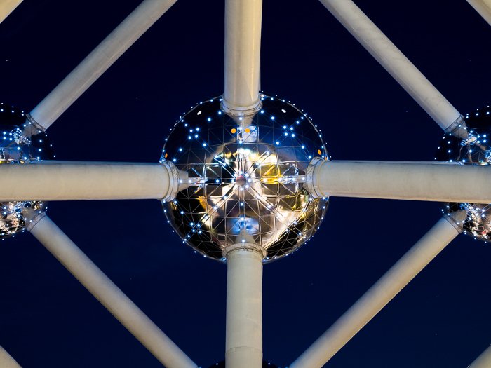 Close up detail of a part of the The Atomium, city lights reflecting in the sphere